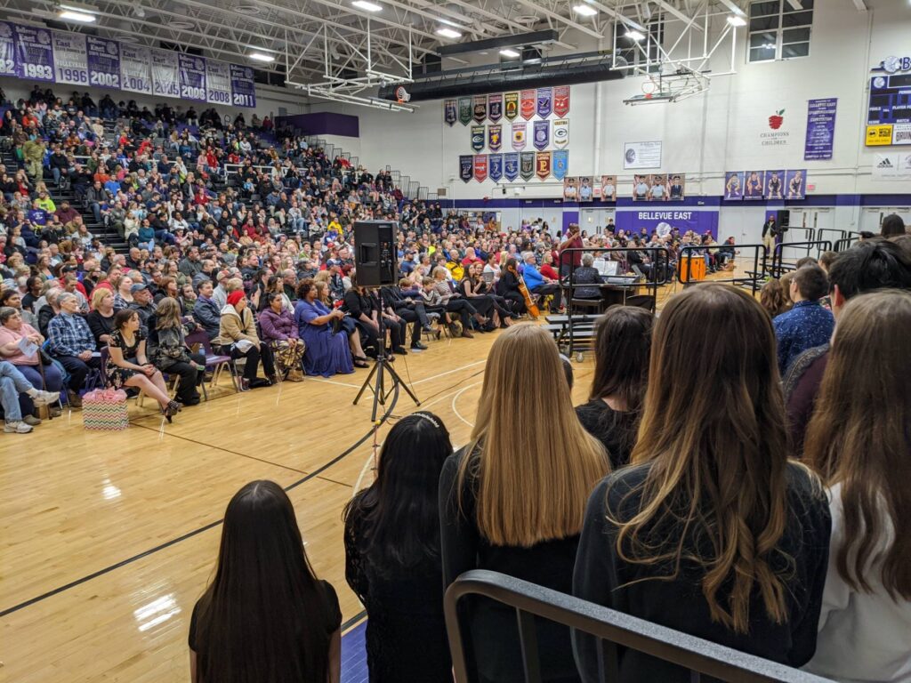 school gym full of choral festival attendees