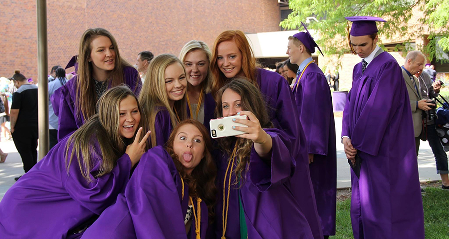 Several girls in purple graduation gowns.